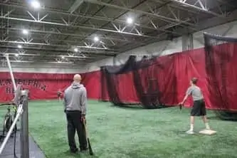 Philadelphia Reds teacher performing drills with students, baseball training