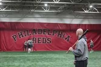 Philadelphia Reds teacher performing drills with students, baseball training