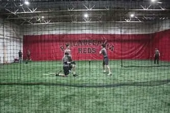 Student in his batting stance at Philadelphia Reds baseball training academy